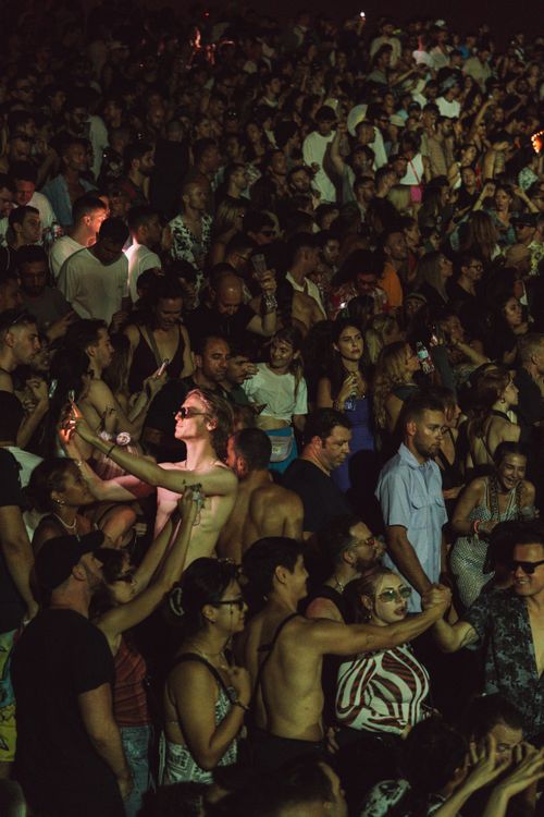 Free Vibrant crowd enjoying a nighttime music festival, capturing the essence of shared excitement. Stock Photo