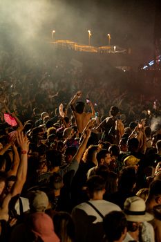 A lively crowd enjoying a night music festival with vibrant atmosphere.