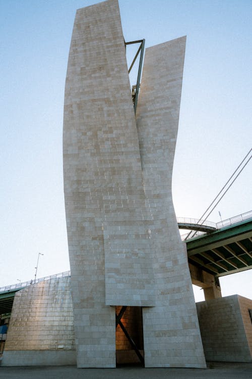 A large white building with a bridge in the background