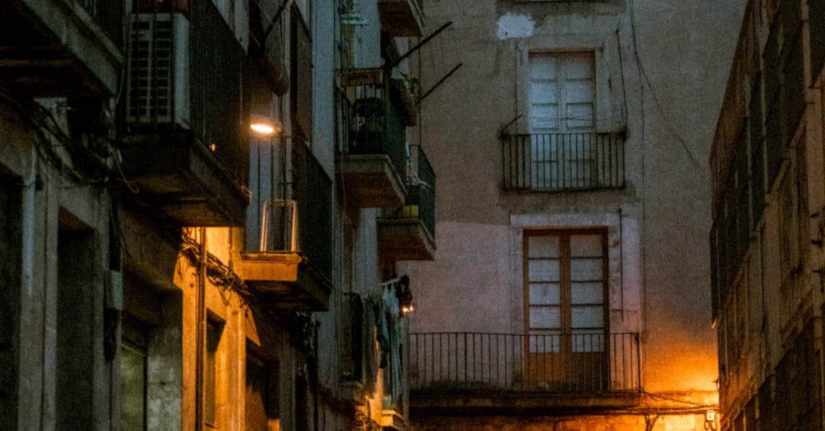 Photo of an Illuminated Alley between Apartment Buildings in a City ...