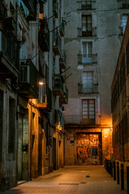 Photo of an Illuminated Alley between Apartment Buildings in a City ...