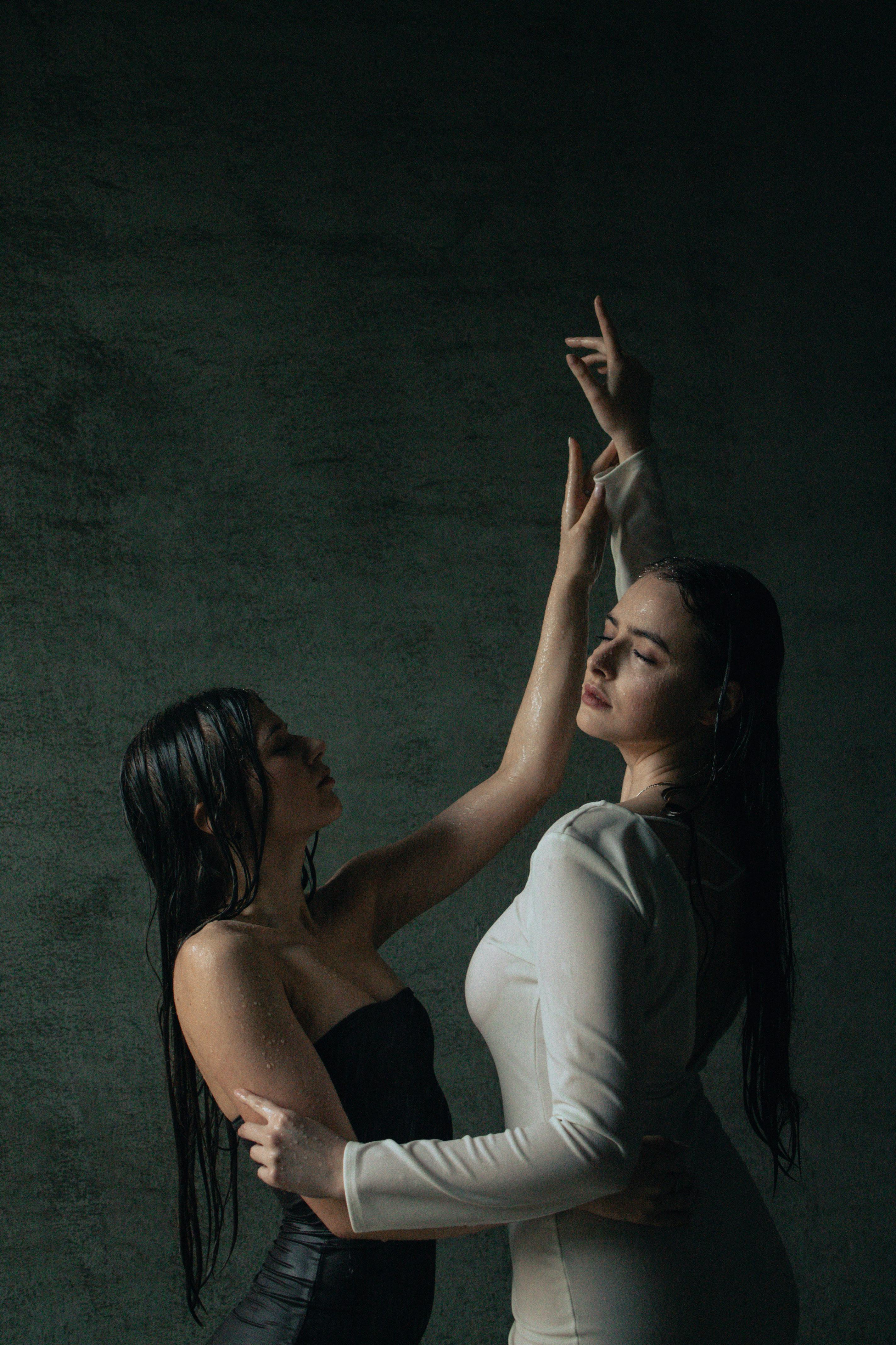 Two Women Posing in Wet Clothes · Free Stock Photo