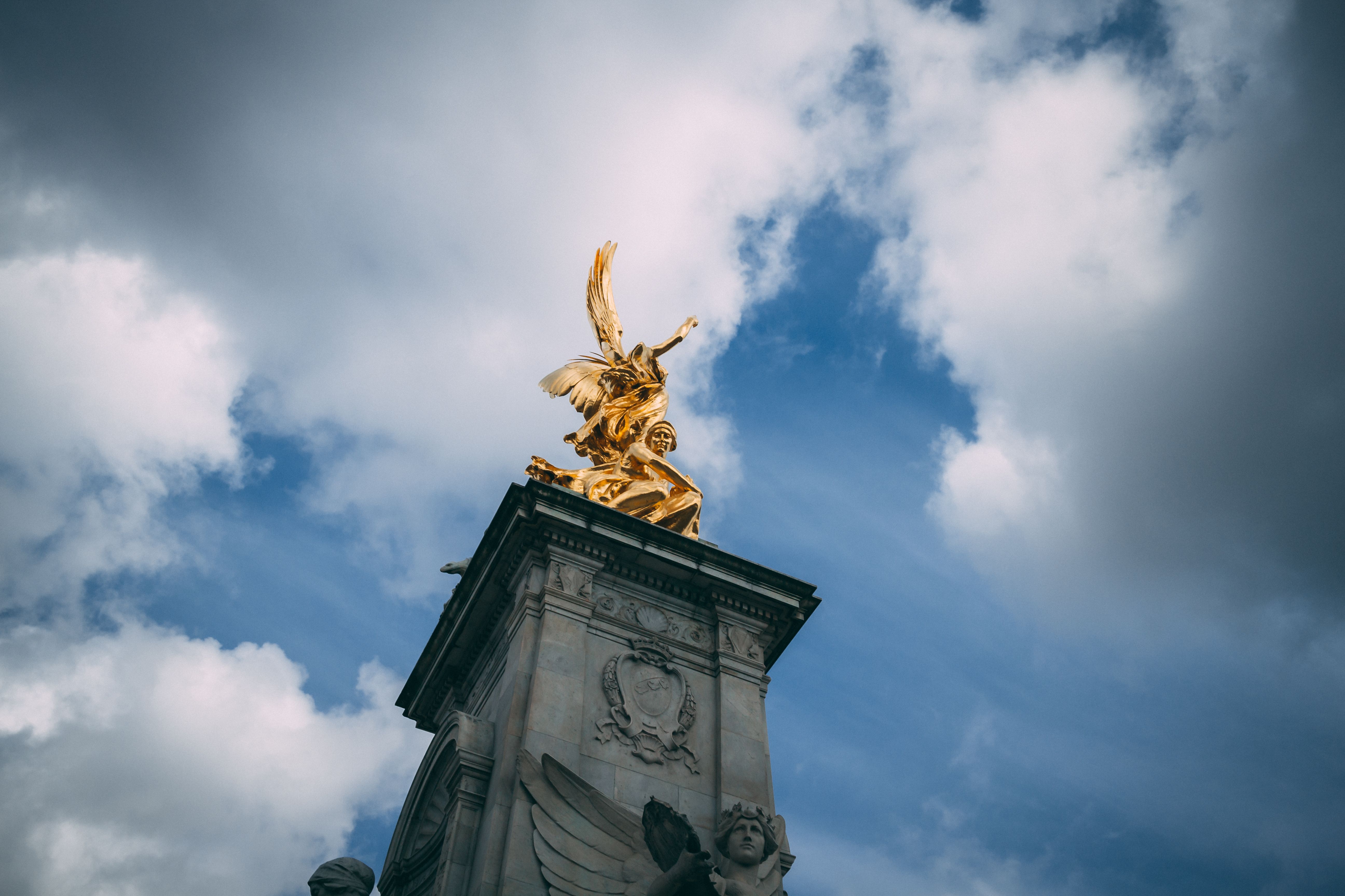 Elegant view of the Victoria Memorial in London under a dynamic cloud-filled sky.