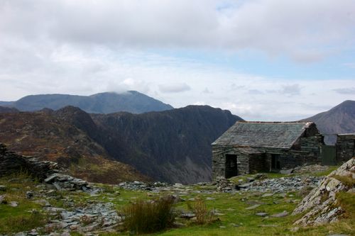Free A scenic view of a stone hut in the Lake District, England, with mountains in the background. Stock Photo