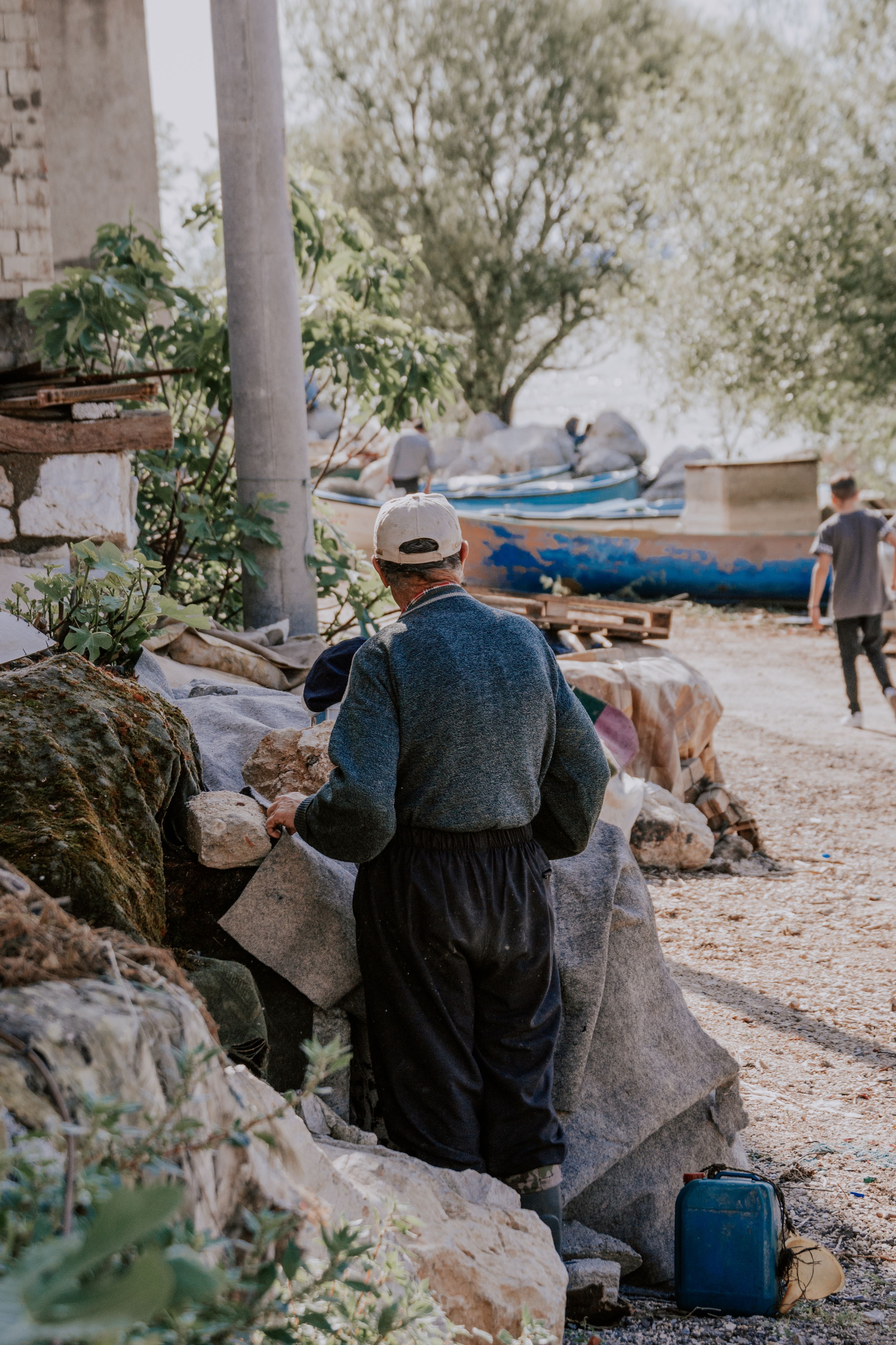 A person working with materials in a rustic, rural village setting.