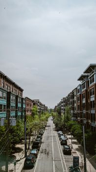 Explore the serene streets of Hoboken, NJ, with urban architecture lining a peaceful road on an overcast day.