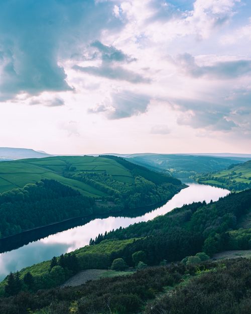 Free Breathtaking aerial view capturing the scenic green hills and river in England. Stock Photo