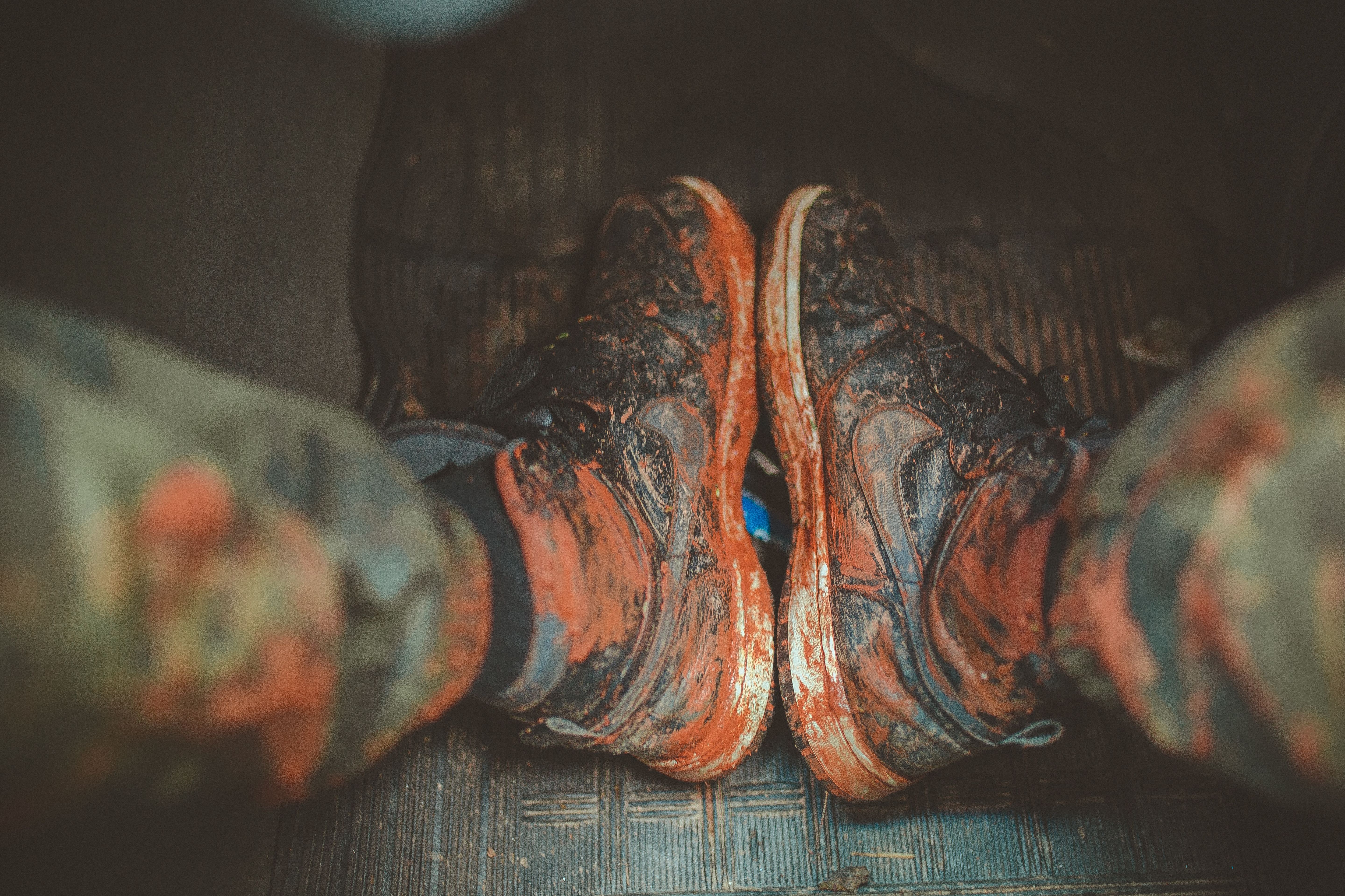 Muddy boots and dirt in a work vehicle footwell before detailing