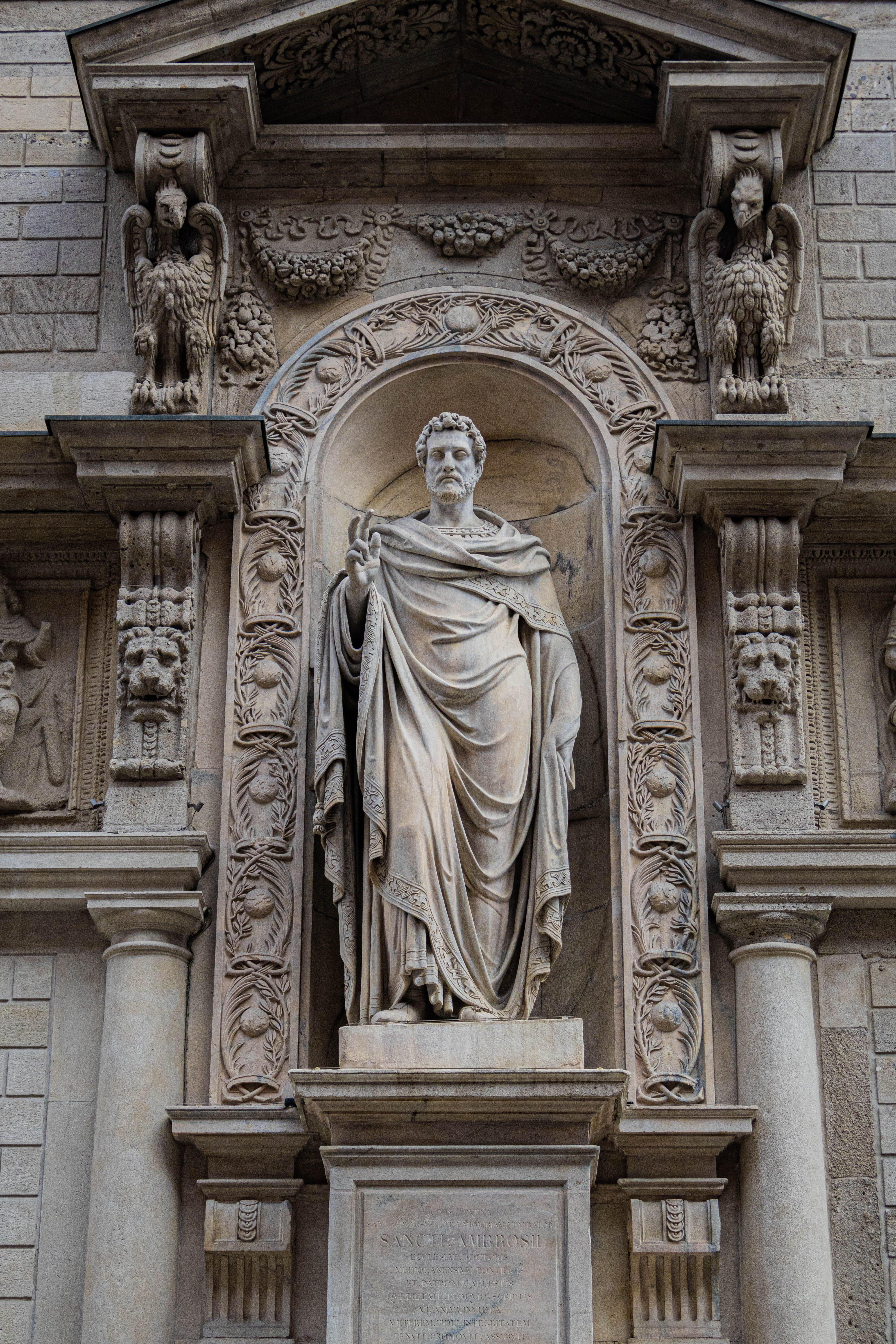 Detailed view of a classical statue at Galleria Vittorio Emanuele II, Milan, Italy.
