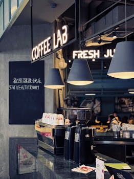 Stylish café interior featuring coffee equipment and modern lighting, creating a cozy atmosphere.