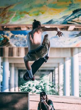Skateboarder performs mid-air trick in vibrant urban skate park setting.. skateboarder, performs, trick