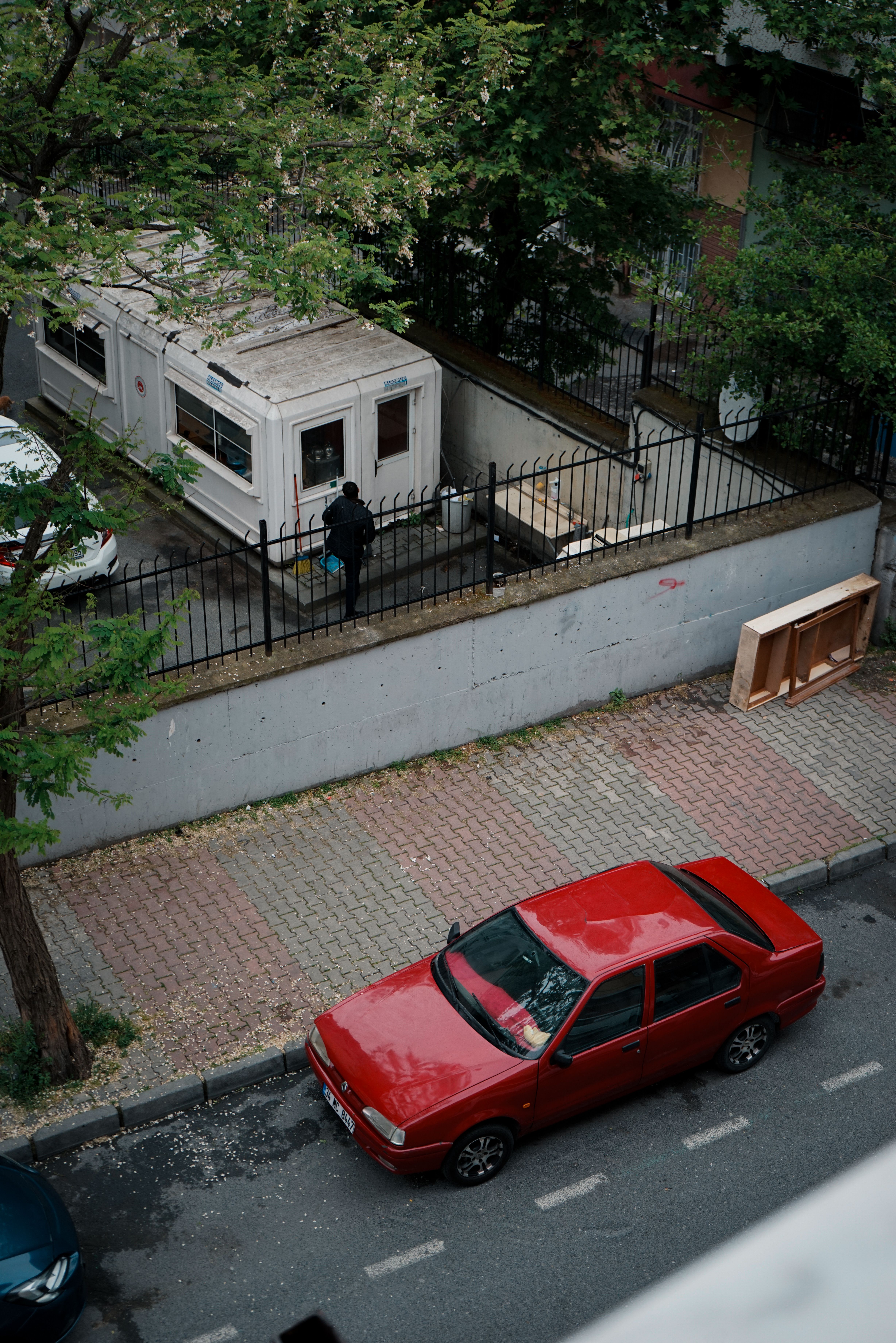 A red car parked in front of a building · Free Stock Photo