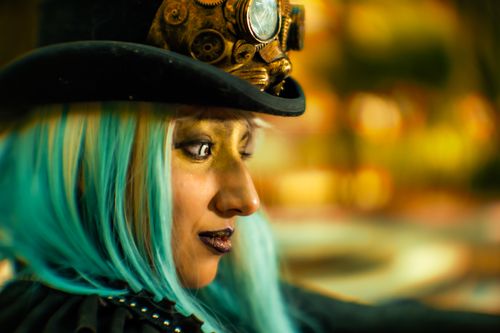 Free Vibrant portrait of a woman in steampunk costume with blue hair and hat. Stock Photo