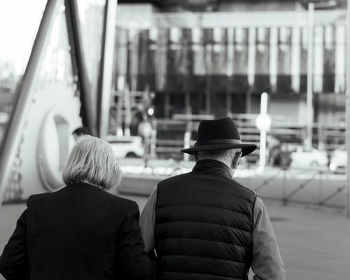 Free A senior couple walking together on a city street in Spain. Stock Photo