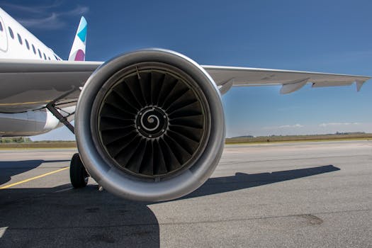 Detailed view of a jet engine and wing on runway at Sylt Airport on a sunny day.