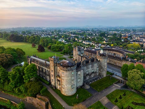 Stunning aerial view of medieval Kilkenny Castle and lush surroundings in Ireland.