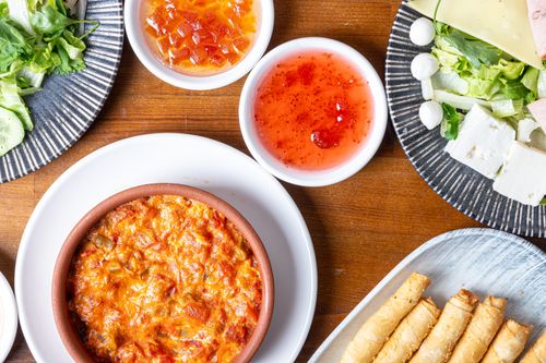 Free A vibrant spread of appetizers including cheese, salad, and dip. Perfect for gastronomy lovers. Stock Photo