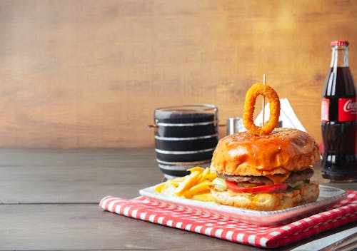 A hamburger with fries and soda on a table