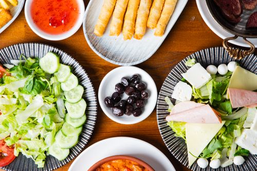 Free A vibrant array of Mediterranean appetizers including salads, olives, and rolled pastries for a delightful dining experience. Stock Photo