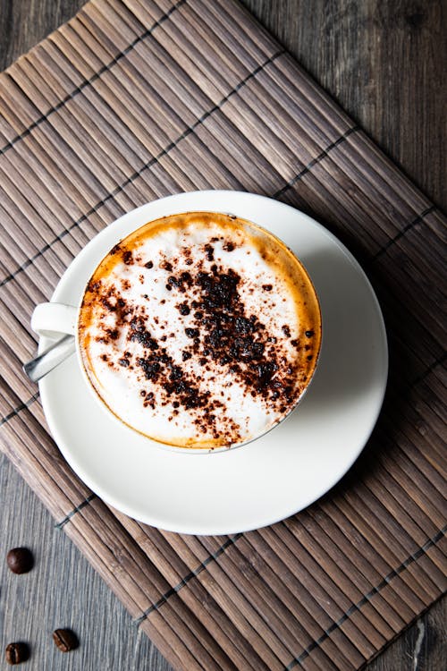 A cup of coffee with chocolate sprinkles on top