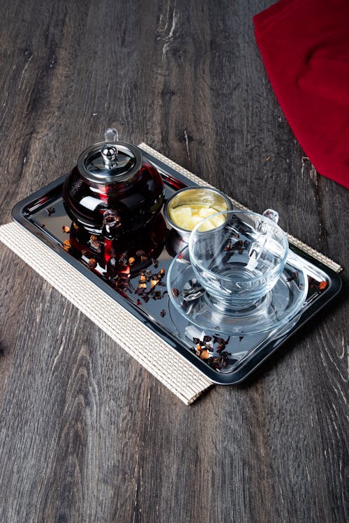 A tray with a glass and a candle on it