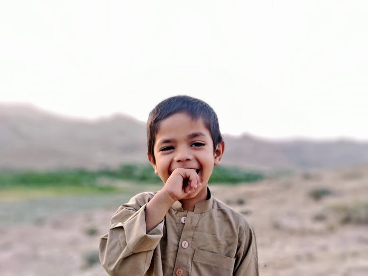 Photo Of Boy Biting His Right Hand