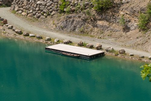 Free Quiet scene of a wooden dock on a calm lake in rural Voćin, Croatia. Stock Photo