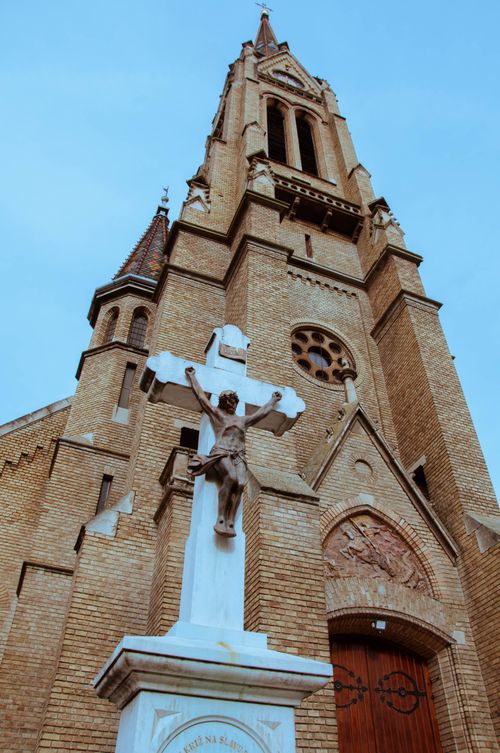 Free Stunning architectural shot of Subotica Cathedral featuring a prominent Christ sculpture in Vojvodina, Serbia. Stock Photo