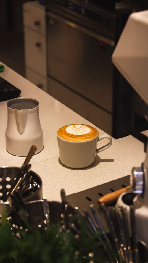 Free Inviting café ambiance with cappuccino and latte art on a counter in Istanbul. Stock Photo