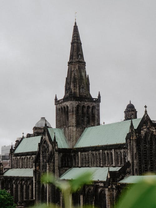 Brown and Teal Roofed Building Under White Sky