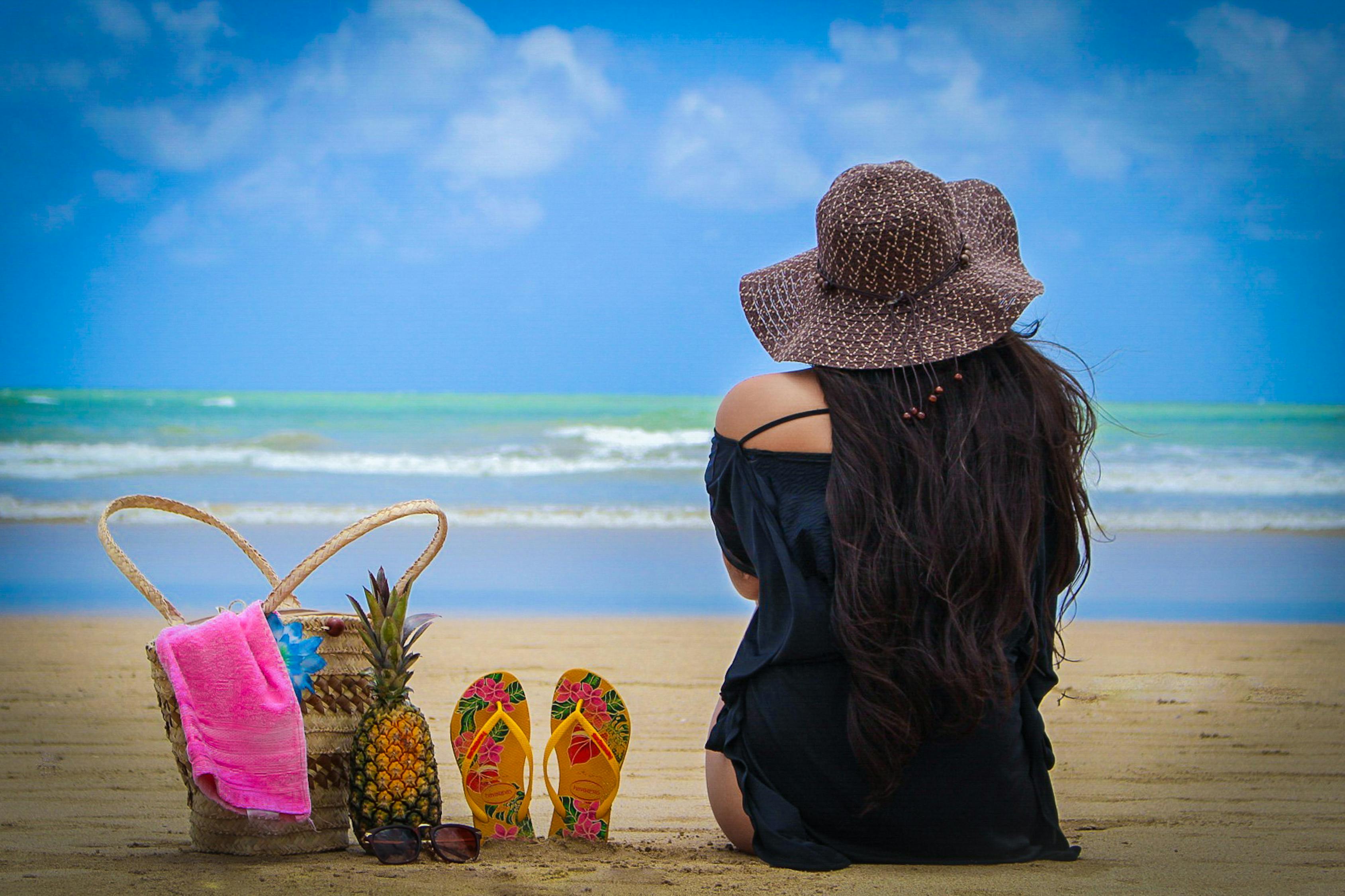 Photo of Woman Sitting on Beach · Free Stock Photo