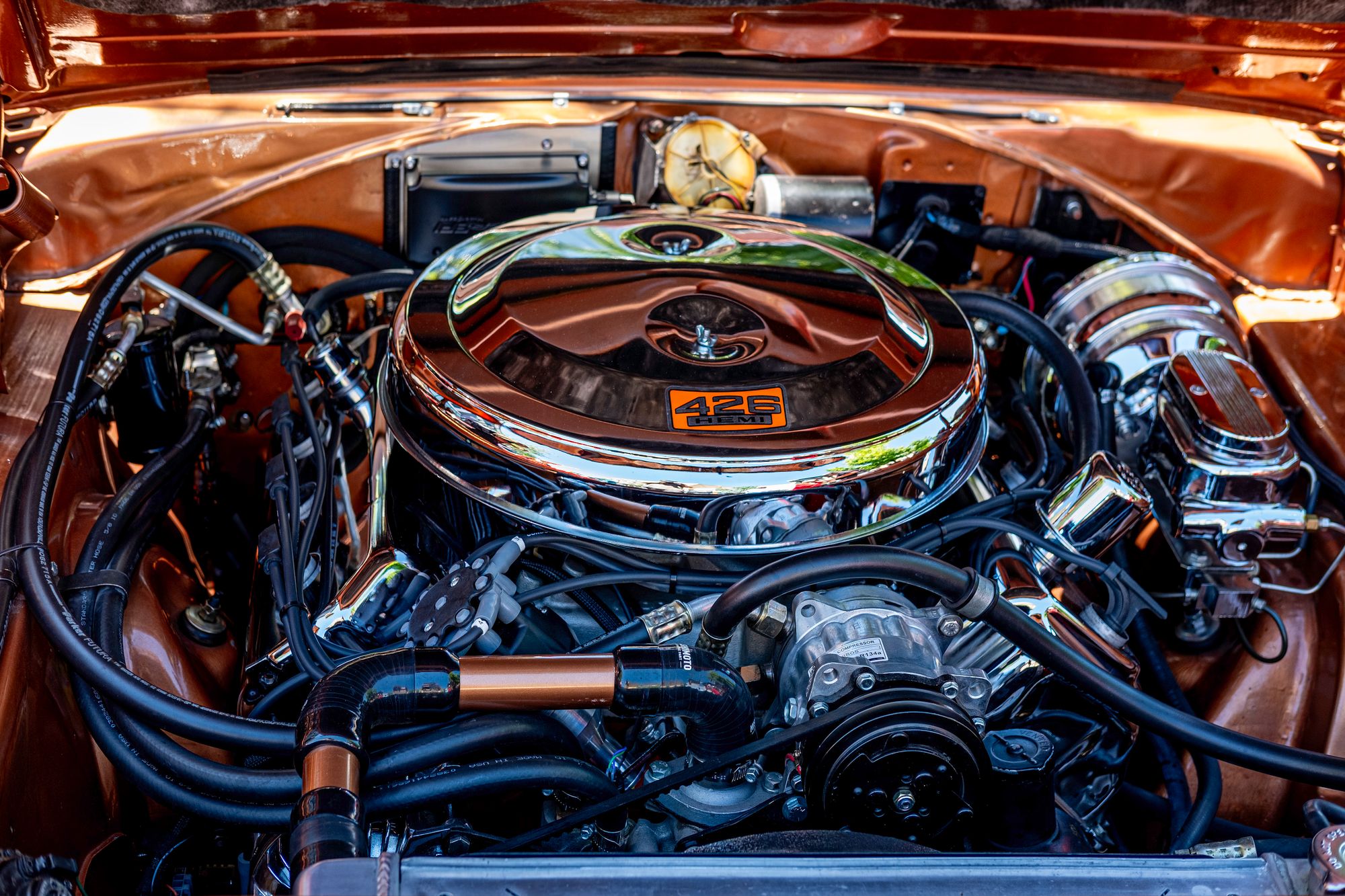 Image 0 shows a vintage 426 Hemi engine in a period-correct engine bay, directly matching the article