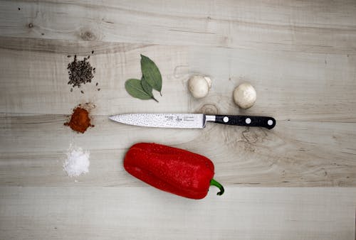 Free Kitchen Knife Placed Next to Pepper Stock Photo