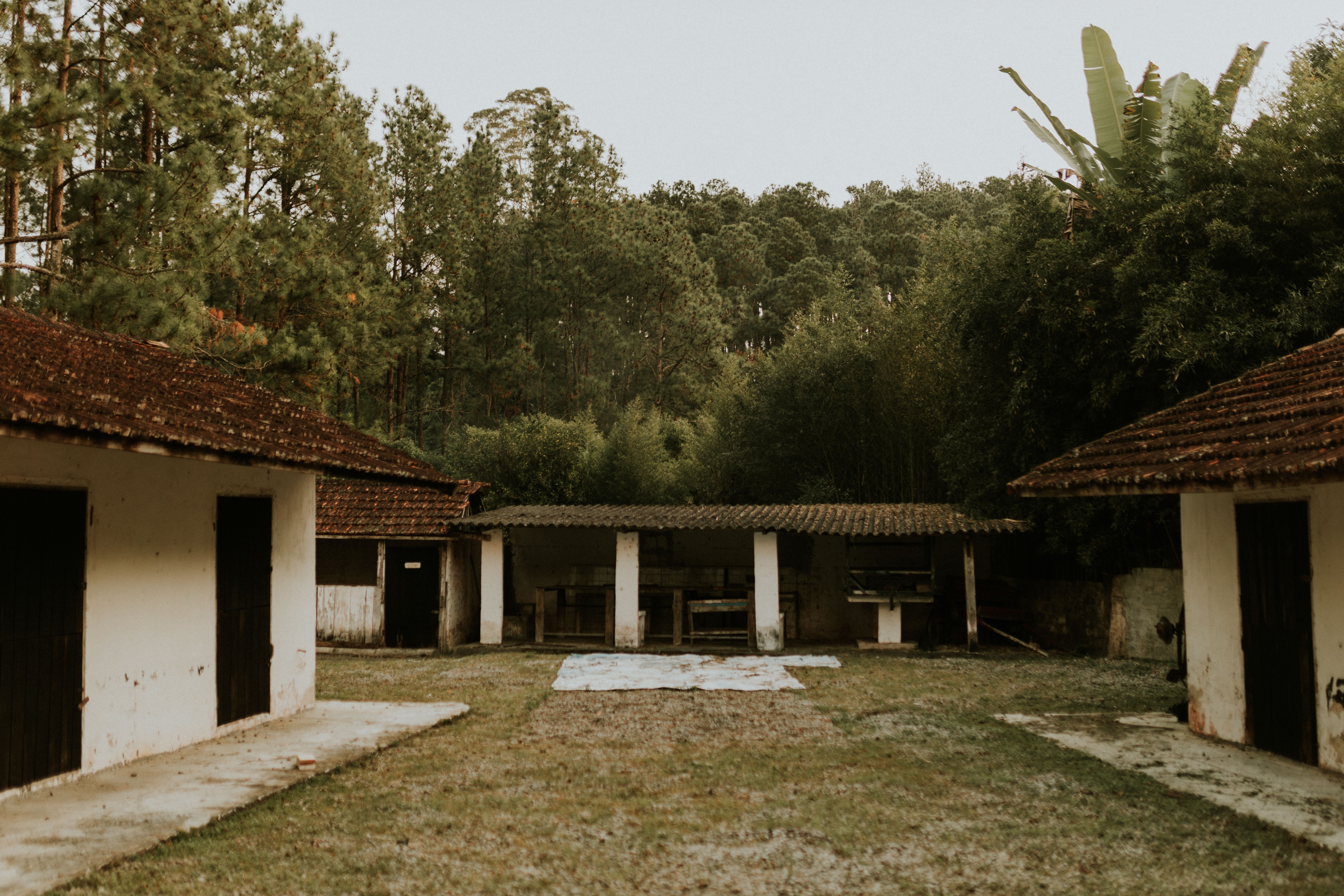 Simple guesthouse rooms around a tiled courtyard in a Honduran highland town