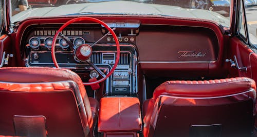 The interior of a classic car with red leather seats