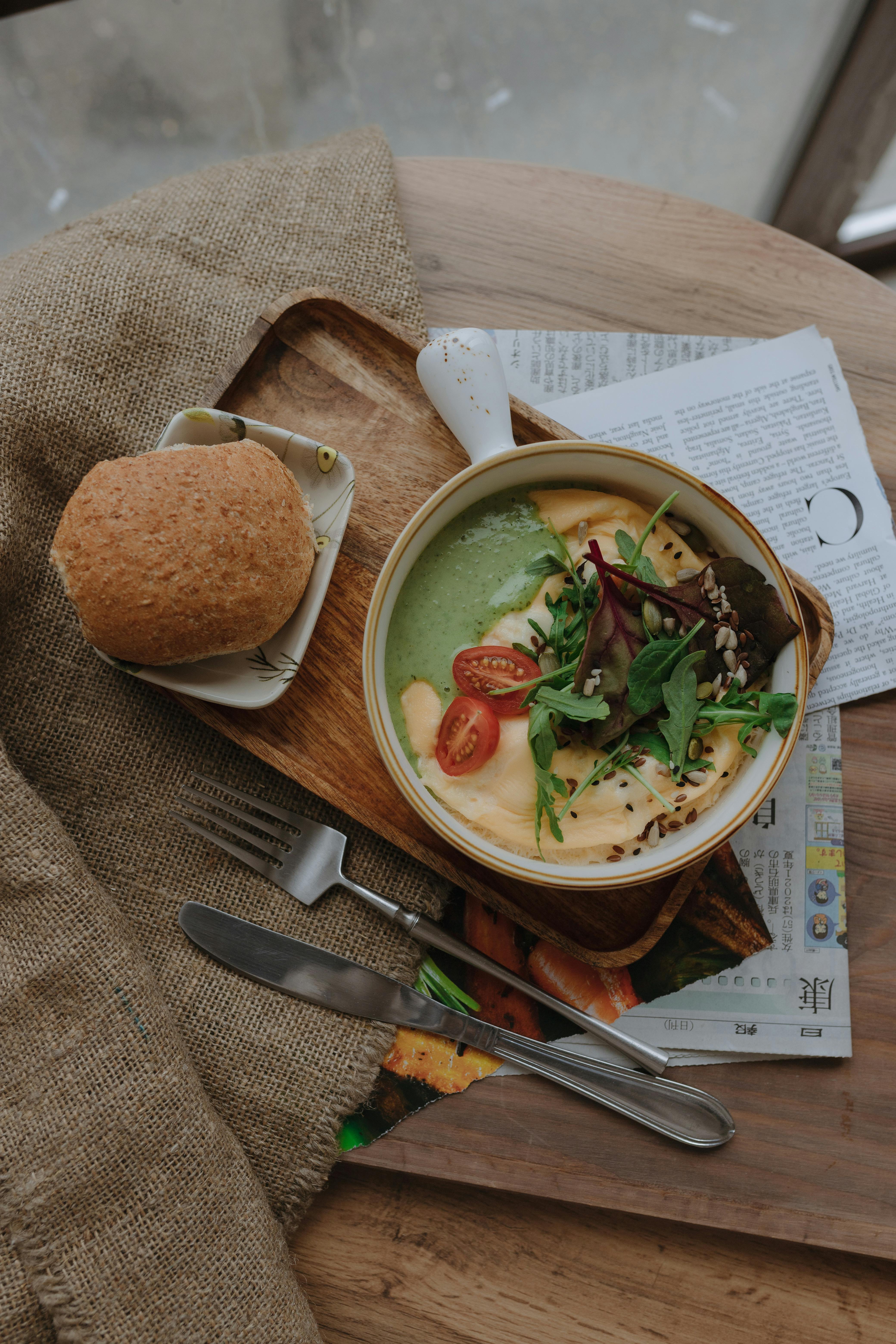 cream soup in bowl and roll on tray