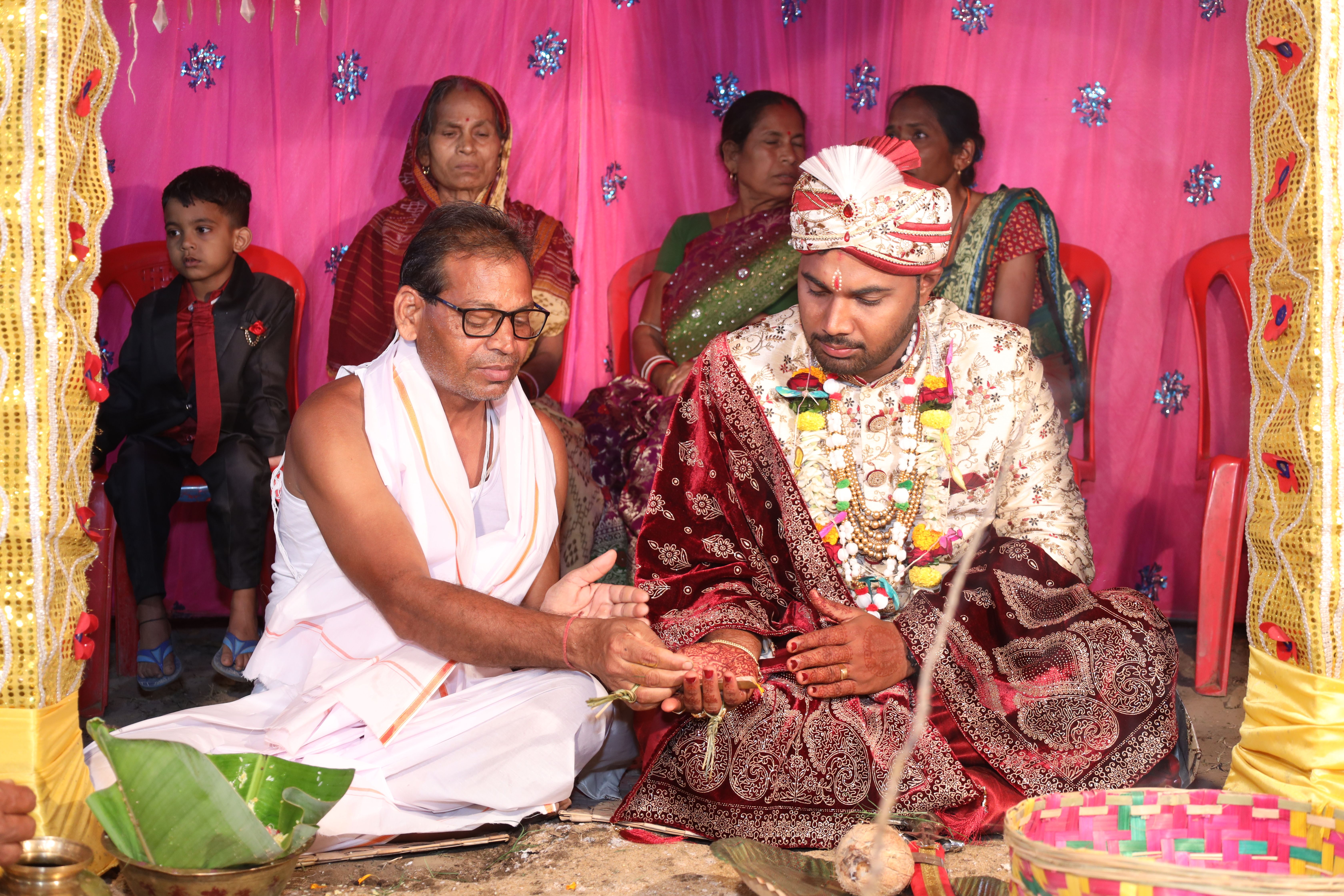 A man in traditional attire is giving a woman a ring · Free Stock Photo