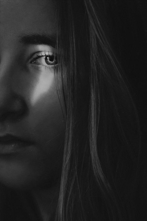 Free Dramatic black and white close-up portrait of a woman with intense gaze. Stock Photo