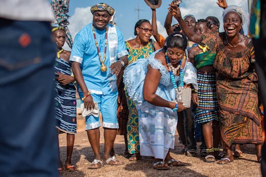 在晴朗的天空下，人们穿着传统服装，欢乐地跳舞庆祝户外聚会