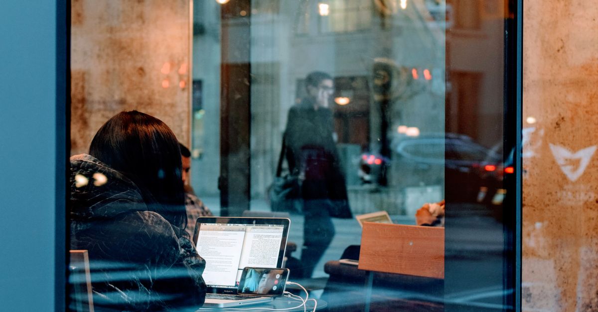 Laptop on a desk in a modern coworking space — best remote work cities 2026