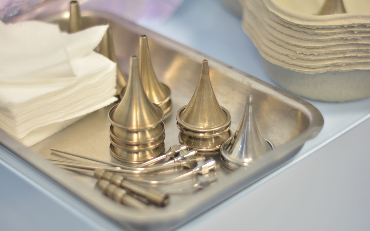 Sterile medical instruments and paper napkins arranged neatly in a clinic setting.