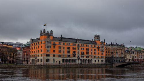 Free Historic Rosenbad building in Stockholm by the river under a cloudy sky, showcasing Swedish architecture. Stock Photo