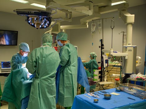 A surgical team working in a well-equipped operating room with advanced medical tools.