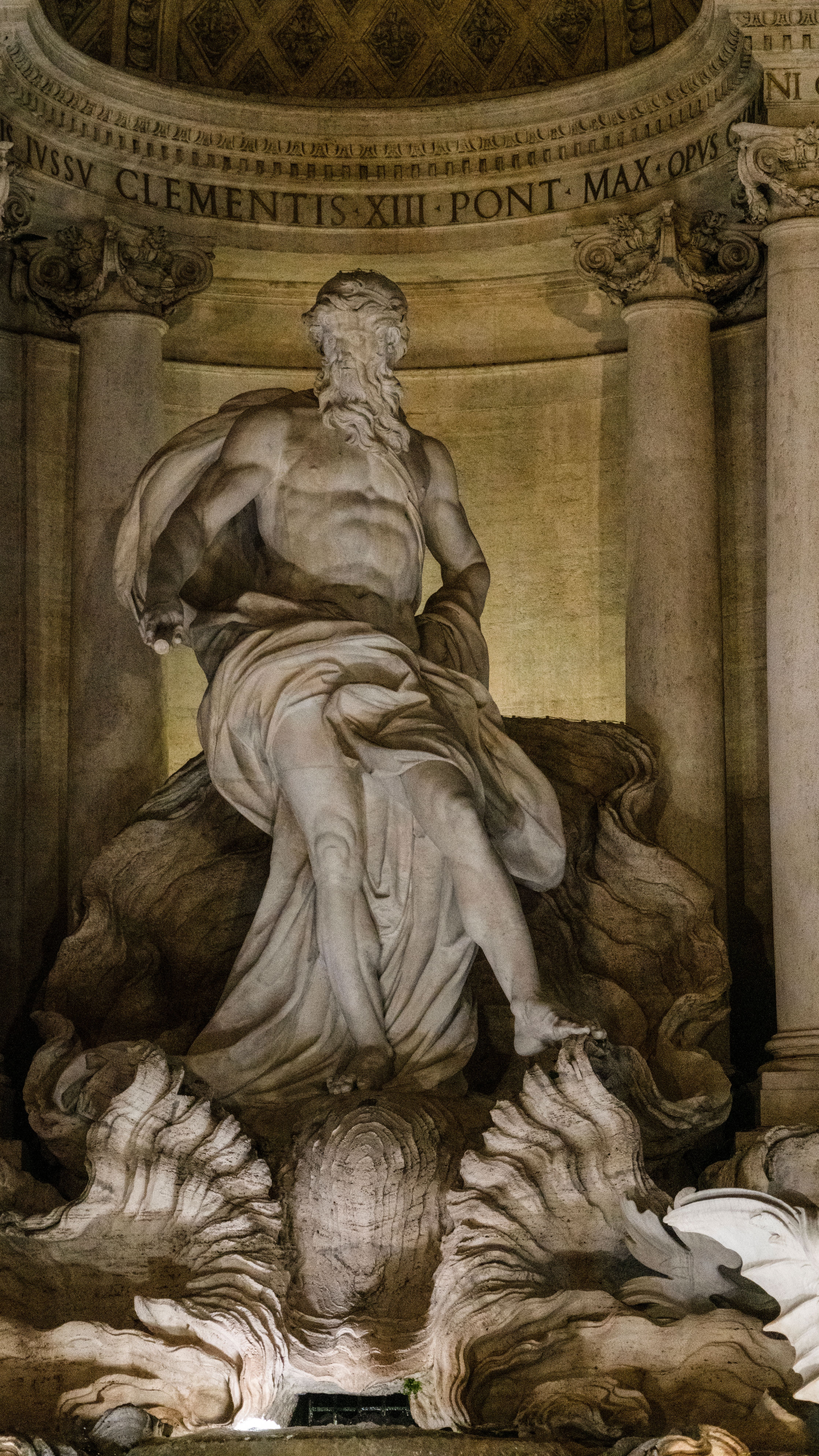Close-up of Oceanus statue, part of the Trevi Fountain in Rome, showcasing its intricate 18th-century design.