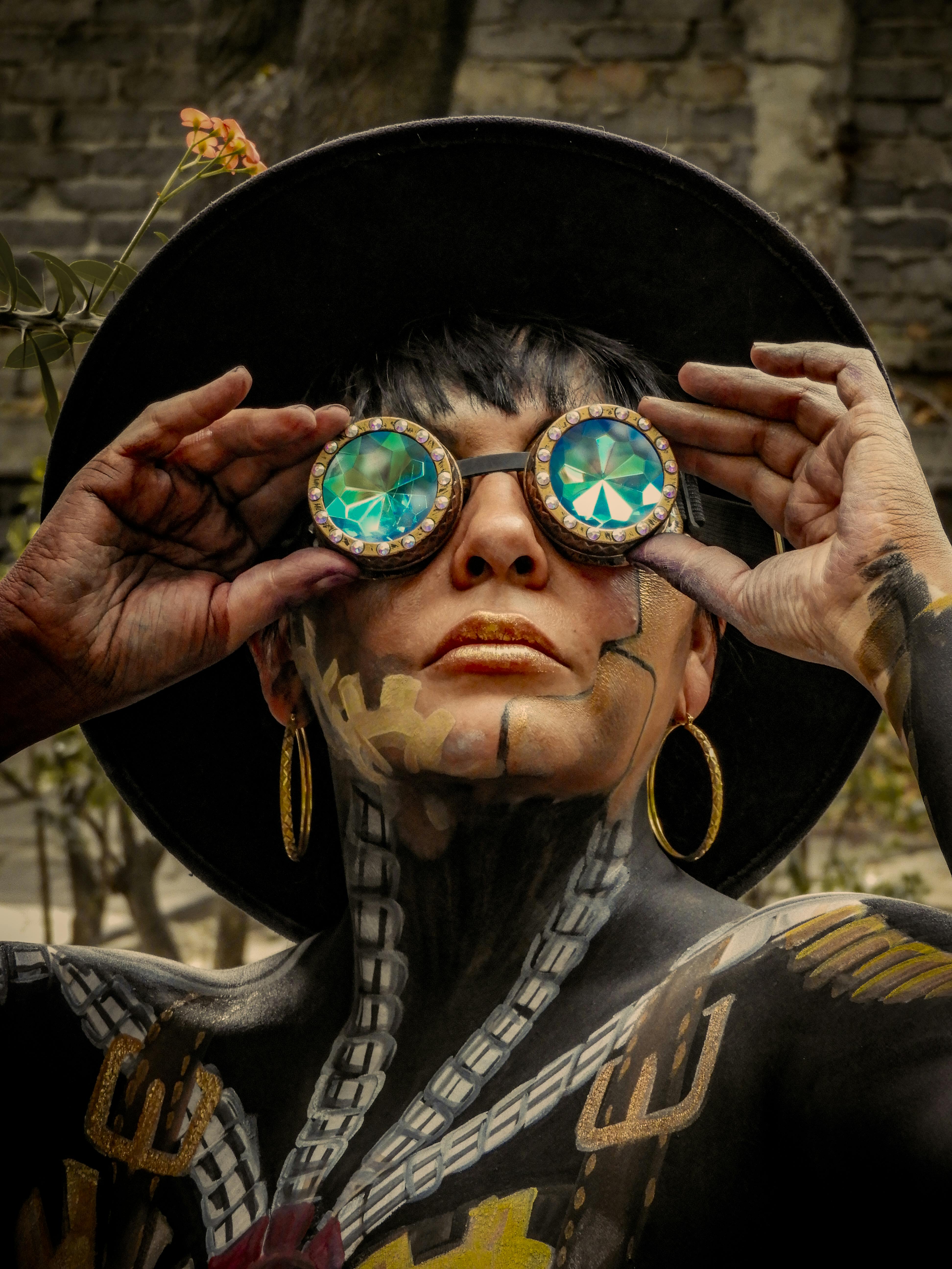 Steampunk-themed portrait of a woman wearing goggles and body paint.