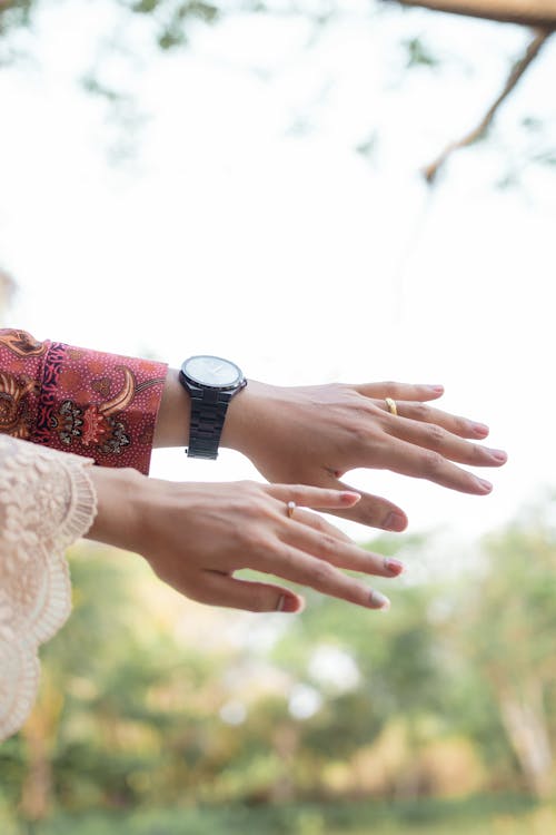 A woman's hands are reaching out to another person