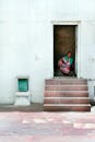 Woman Sitting Inside House