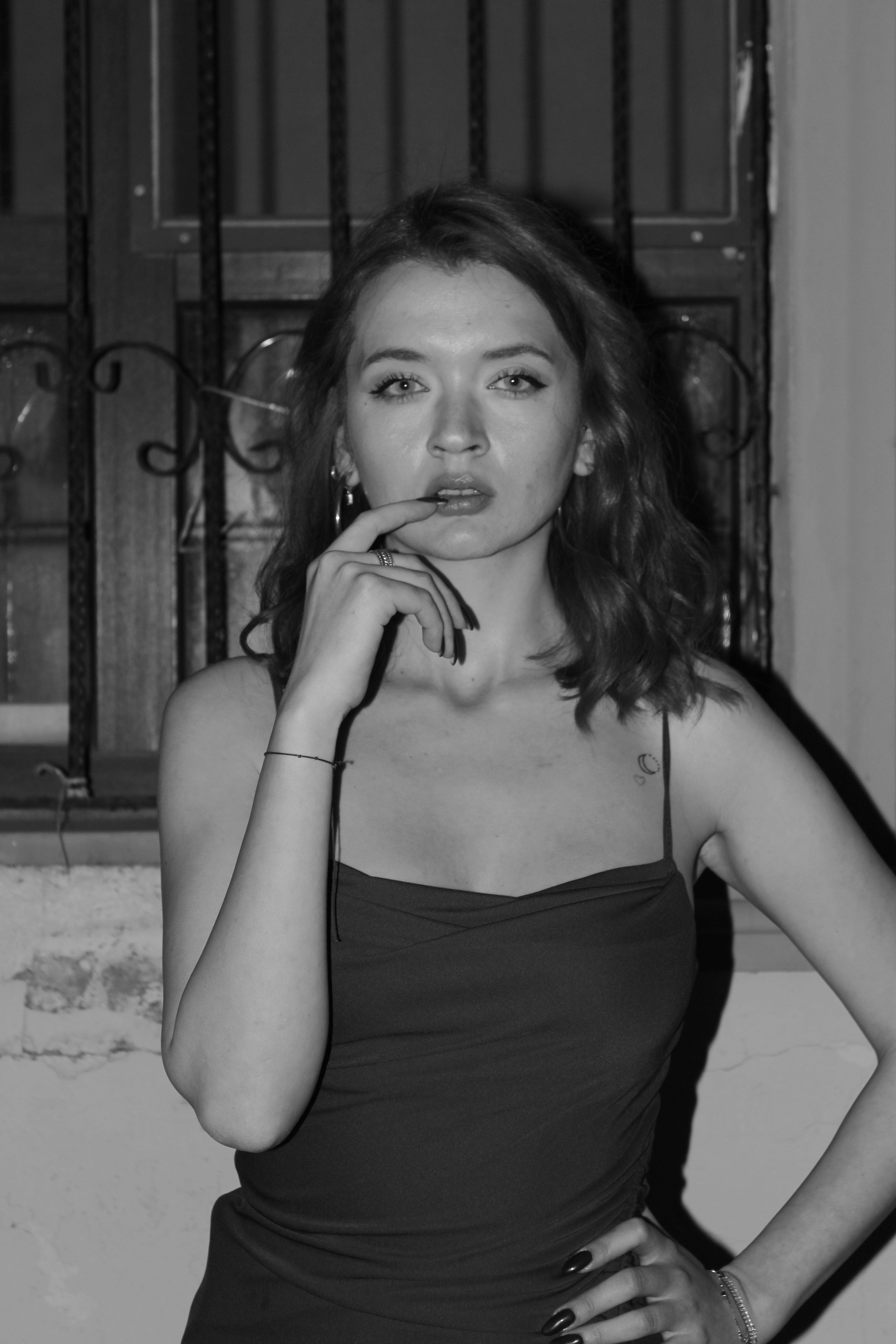 Stunning black and white portrait of a woman posing outdoors at night.