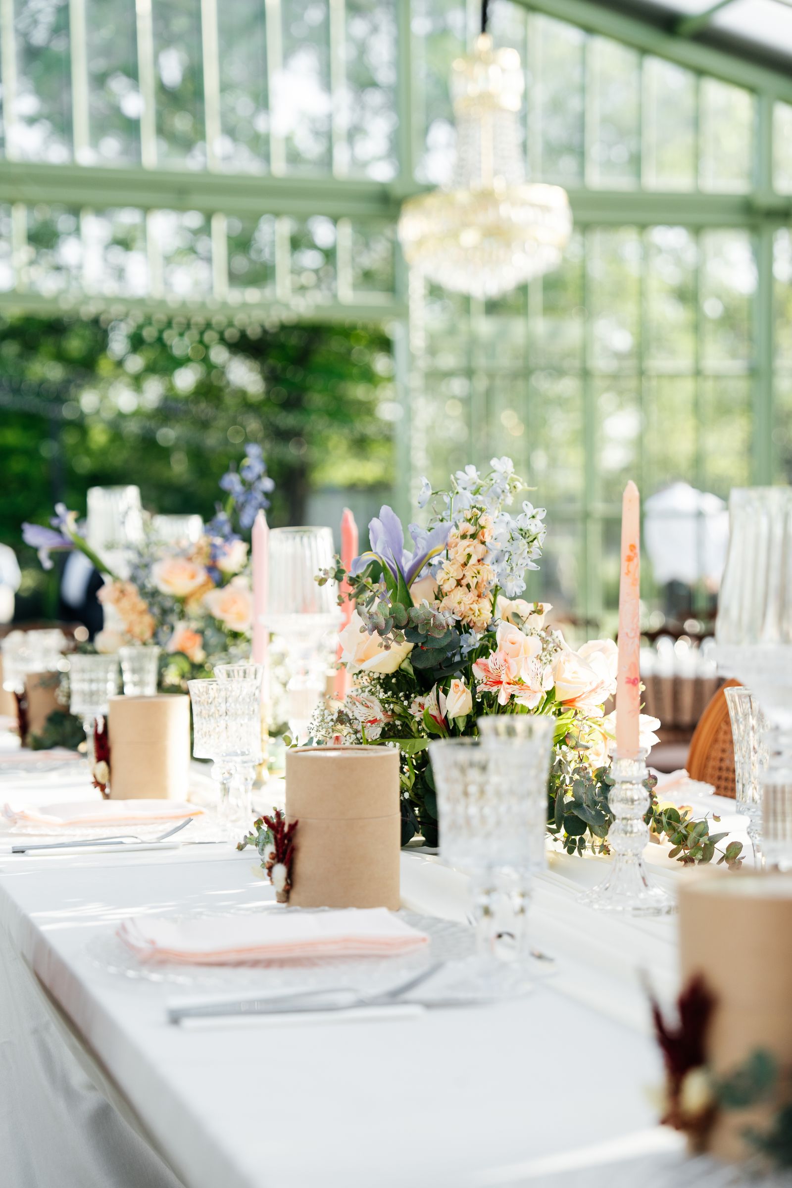 Elegant wedding reception table set with flowers and candles in a sunlit room