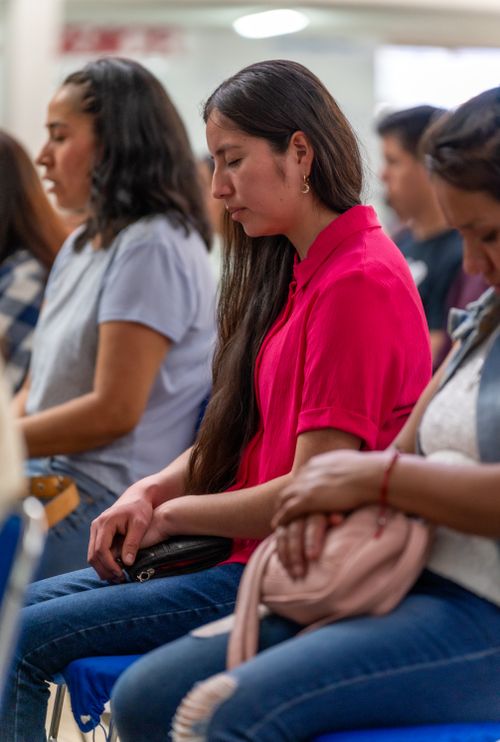 Free Women engage in silent prayer during a spiritual gathering in Mexico City, focusing on peace and faith. Stock Photo
